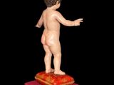 a small figurine of a boy standing on a red box