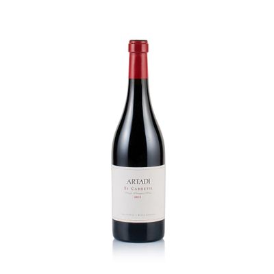 a bottle of red wine sitting on top of a white surface