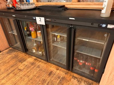 a black counter with a glass door that has bottles on it
