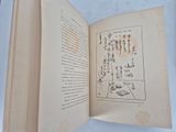 an open book with chinese writing on it on a table