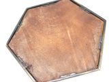 a metal tray that has a brown leather covering on it