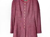 purple jacket on a hanger on a white wall