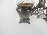a silver vase with a glass lid on a table