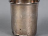 a silver cup that is sitting on a table