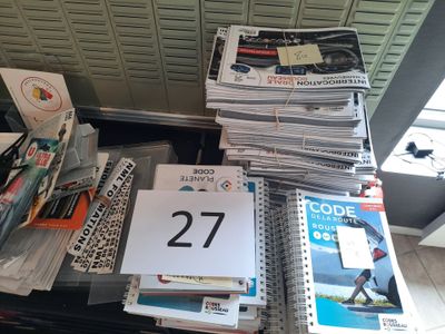a lot of books and magazines on a table