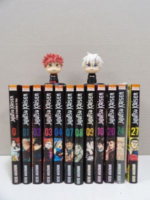 a lot of anime books stacked on top of each other