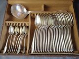 a lot of silver spoons and spoons in a box