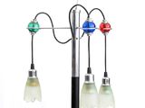 three lights that are attached to a pole on a white background