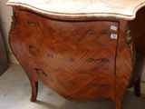 a small chest of drawers in the corner of a room
