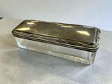 a silver plated box on a table with a white background