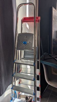 a ladder that is leaning against a wall in a room