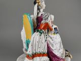 an image of a figurine of a woman sitting on a chair