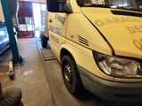a van that is parked in a garage with a sign on it
