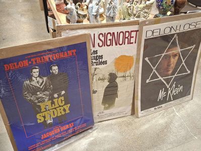 three movie posters on display in a store