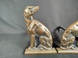 pair of antique brass dog bookends on stand on grey background