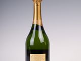 a close up of a bottle of champagne on a white surface
