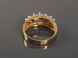 a close up of a gold ring with pearls on a table
