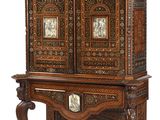 an old wooden cabinet with a clock on top of it