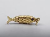 an image of a gold fish broochle on a white background