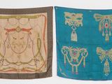 two pieces of cloth with designs on them hanging on a wall