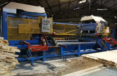 a machine that is working on a piece of wood