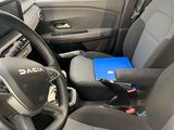 the interior of a car with a laptop on the steering wheel