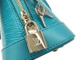 blue purse with a key and a lock on a white background