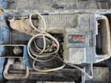 une boîte à outils contenant des outils, posée sur un plancher en bois