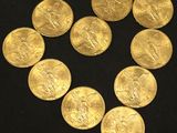 gold coins arranged in the shape of a heart on a black surface