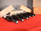 several bottles of wine are lined up in a row on a table