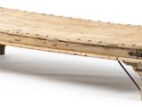 a small wooden bench with metal legs on a white background