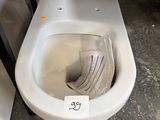 a toilet with a seat that has a paper in it