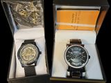 two watches that are in a box on the table