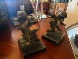 two figurines of angels on a wooden table