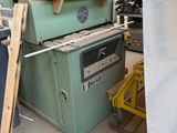 a pile of old appliances in a room with a ladder