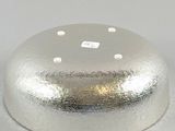 a silver cake cover on a white table