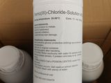 a bottle of liquid sitting on top of a cardboard box