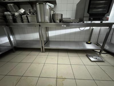 une photo d'une cuisine avec de nombreuses casseroles et poêles posées sur le plan de travail