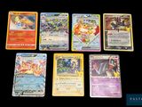 several different pokemon cards sitting on top of a black table