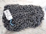 a close up of a pile of metal chain with a tag on it