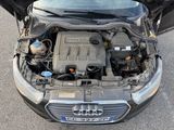 a car engine with the hood open on the street