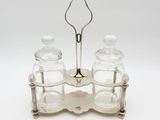 a pair of glass salt and pepper shakers on a stand