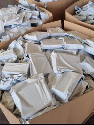 several boxes filled with packages sitting on top of a carpeted floor