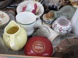 many different types of pottery on display in a box