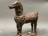 a statue of a horse with a saddle on it ' s back