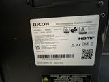 a label on the back of a machine that says ricoh