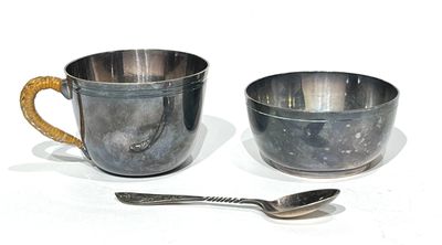 two cups and a spoon sitting on a table