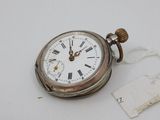 a silver pocket watch with roman numerals on it