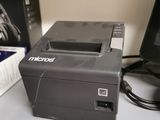 a printer sitting on a desk next to a monitor