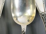 two spoons that are sitting next to each other on a table